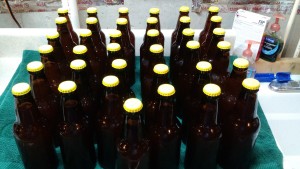 Boring pic of yellow capped bottles of lager